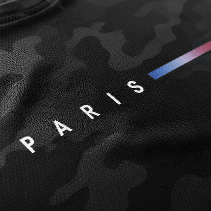 Close-up of camouflage pattern and bold PARIS lettering print detail on black polyester tank top fabric